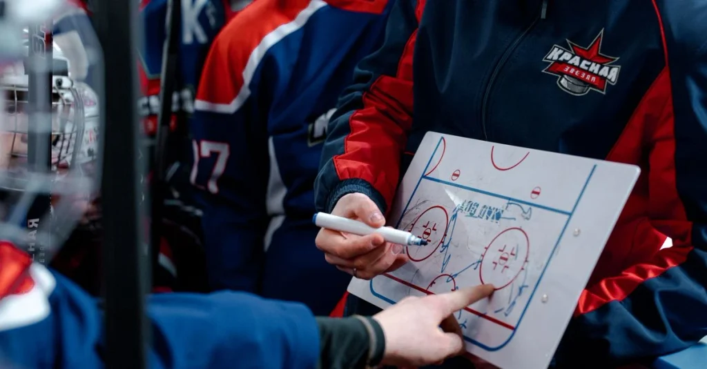 Hockey teammates celebrate together on the ice after a successful play