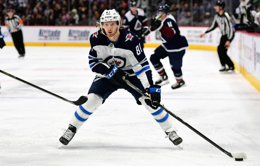 Hockey players move the puck with a quick pass during an offensive rush
