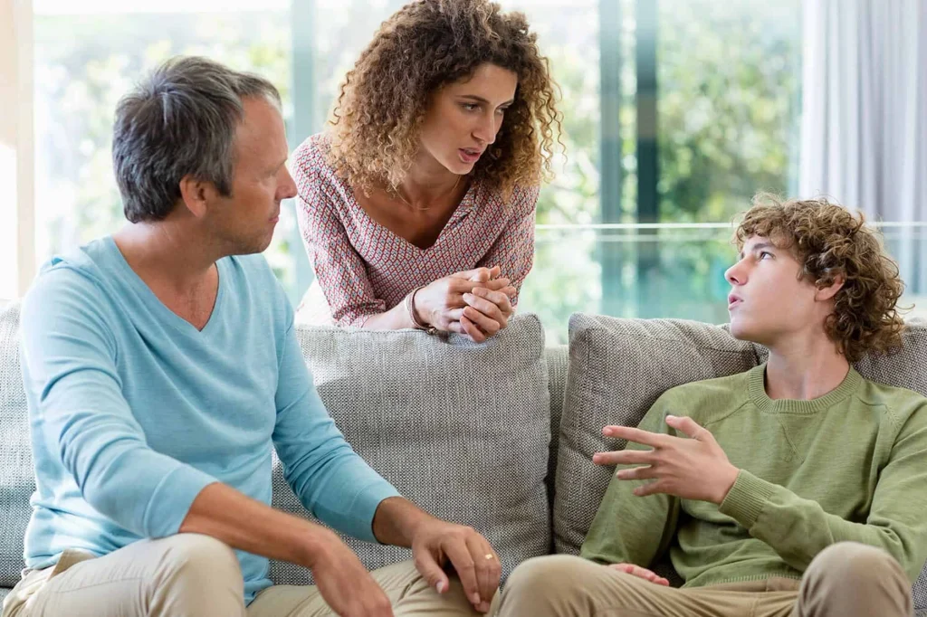 Parent and child look at a smartphone together while discussing online content